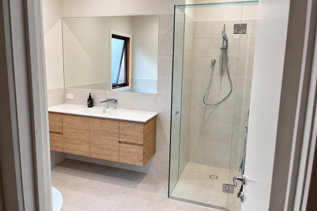 Stepless shower with frameless glass screen and natural large format tiles, Healesville